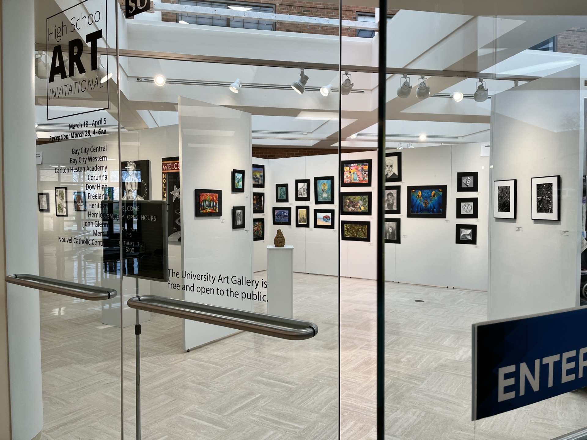open door with names of highschools on glass, BC Central work with heritage work in the background